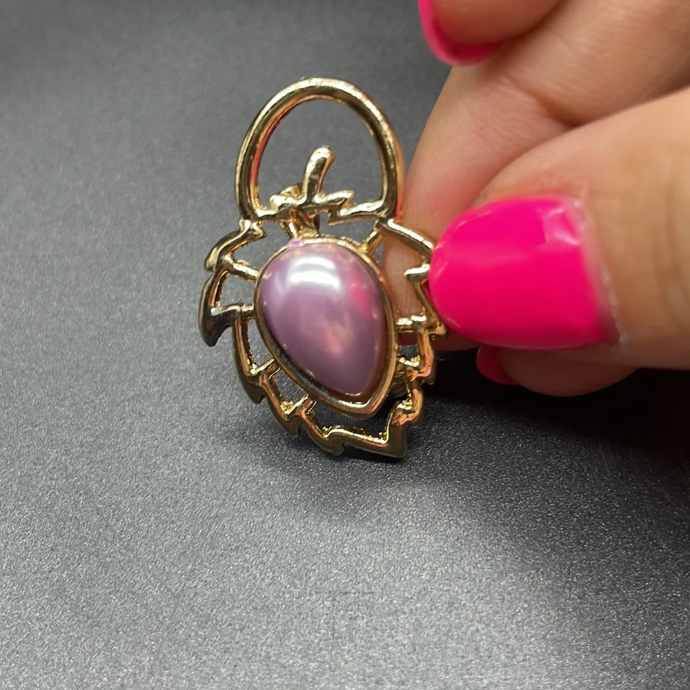 Gold plated brooch with a stone in the center | the stone color is a lavender
